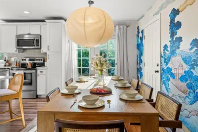 a dining room with a table and a chandelier at 5BD Japanese-Themed w/ Hot Tub, Movie Room & Games in Arvada