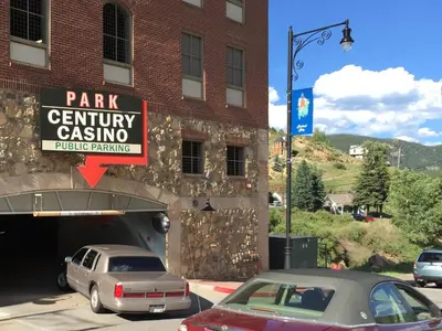 a parking garage with cars parked in front of a building at Century Casino & Hotel - Central City in Central City