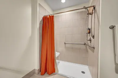 an orange shower curtain is in a bathroom at Century Casino & Hotel - Central City in Central City