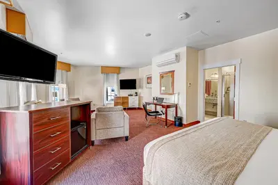 a hotel room with a bed and a flat screen tv at Century Casino & Hotel - Central City in Central City