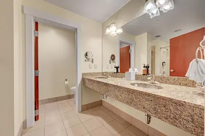 a bathroom with two sinks and a toilet at Century Casino & Hotel - Central City in Central City