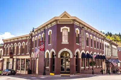 a large brick building with american flags on it at Century Casino & Hotel - Central City in Central City