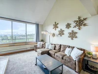 a living room with a couch and a large window at 1-Bedroom plus Loft at The Pines with Forest Views, No Cleaning Fees, Kids Ski Free condo in Keystone