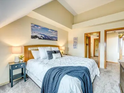 a bedroom with a large bed and a television at 1-Bedroom plus Loft at The Pines with Forest Views, No Cleaning Fees, Kids Ski Free condo in Keystone