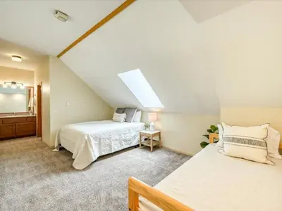 a attic bedroom with two beds and a skylight at 1-Bedroom plus Loft at The Pines with Forest Views, No Cleaning Fees, Kids Ski Free condo in Keystone