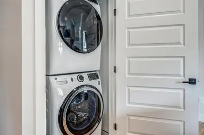 a laundry room with a washer and dryer next to a door at Spacious and Luxurious 2BR Condo - Kids Ski Free condo in Keystone