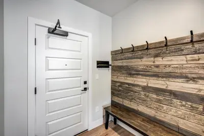 a door in a room with a wooden wall at Spacious and Luxurious 2BR Condo - Kids Ski Free condo in Keystone