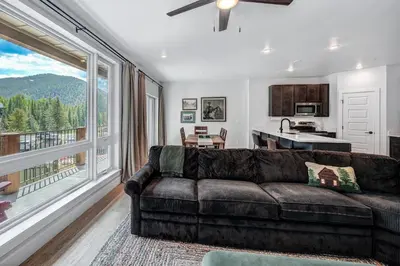 a living room with a couch and a large window at Spacious and Luxurious 2BR Condo - Kids Ski Free condo in Keystone