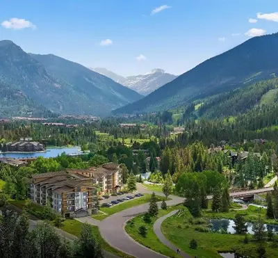 an aerial view of a resort with a river and mountains at Spacious and Luxurious 2BR Condo - Kids Ski Free condo in Keystone
