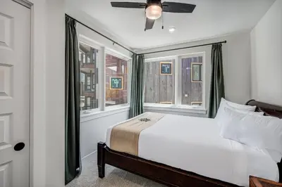 a bedroom with a bed and two windows at Spacious and Luxurious 2BR Condo - Kids Ski Free condo in Keystone