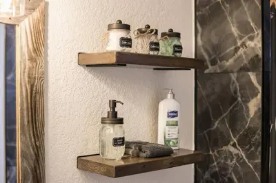 a bathroom shelf with soap and toiletries on it at Luxury Spacious House Great for a Family Retreat in Loveland