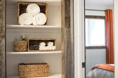 a room with shelves with baskets and towels at Luxury Spacious House Great for a Family Retreat in Loveland