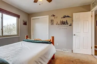 a bedroom with a bed and a window at 3BR Paws & Relax by Sweetheart Stays in Loveland