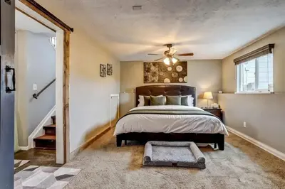 a bedroom with a bed and a ceiling fan at 3BR Paws & Relax by Sweetheart Stays in Loveland