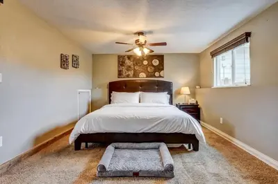 a bedroom with a bed and a ceiling fan at 3BR Paws & Relax by Sweetheart Stays in Loveland