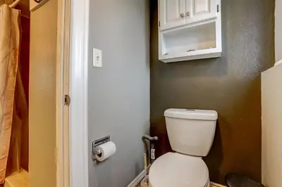 a bathroom with a white toilet in a room at 3BR Paws & Relax by Sweetheart Stays in Loveland