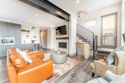an open living room with an orange couch and chairs at 16 Sanctuary Lane in Keystone
