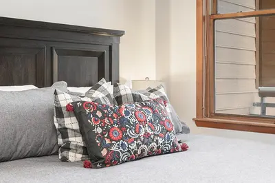 a bedroom with a bed with pillows on it at Ski-In Ski-Out Zephyr 1 Bedroom Condo 2204 in Winter Park