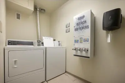 a kitchen with a refrigerator and a sign on the wall at Ski-In Ski-Out Zephyr 1 Bedroom Condo 2204 in Winter Park