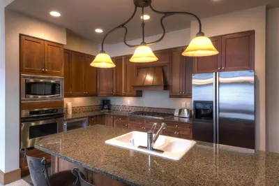 a kitchen with a sink and a refrigerator at Lone Eagle 3052 in Keystone