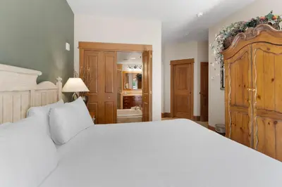 a bedroom with a large white bed and a bathroom at Lone Eagle 3052 in Keystone