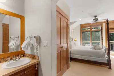 a bathroom with a sink and a bed and a mirror at Lone Eagle 3052 in Keystone