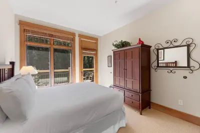 a bedroom with a bed and a mirror and a dresser at Lone Eagle 3052 in Keystone
