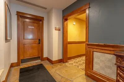 a hallway with a wooden door and aoyer with a rug at Lone Eagle 3052 in Keystone