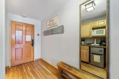 a mirror in a room with a door and a kitchen at Gateway 5028 in Keystone