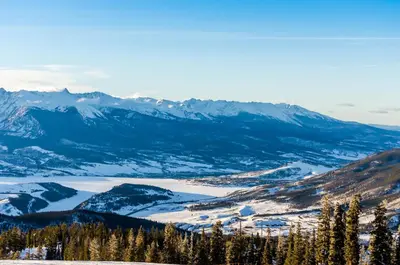a view of a snowy mountain range with a lake at Gateway 5028 in Keystone
