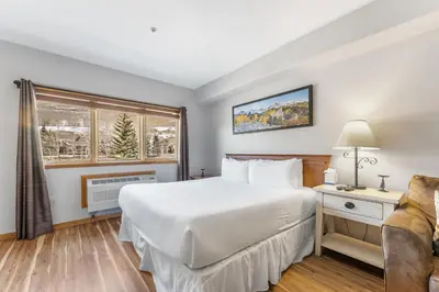 a bedroom with a large white bed and a window at Gateway 5028 in Keystone