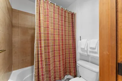 a bathroom with a shower curtain and a toilet at Red Hawk Lodge 2267 in Keystone