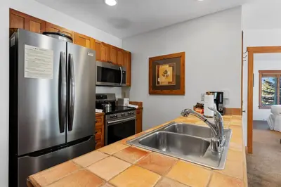 a kitchen with a stainless steel refrigerator and a sink at Red Hawk Lodge 2267 in Keystone
