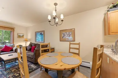 a kitchen and living room with a table and chairs at Expedition Station 8574 in Keystone
