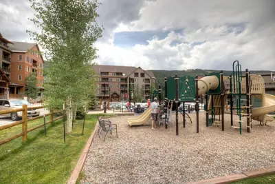 a park with a playground with a slide at Expedition Station 8574 in Keystone