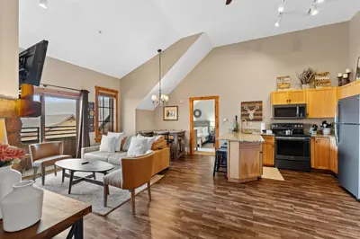 a kitchen and living room with a couch and a table at Dakota Lodge 8538 in Keystone