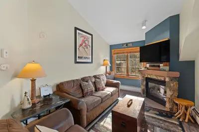 a living room with a couch and a fireplace at Expedition Station 8633 in Keystone