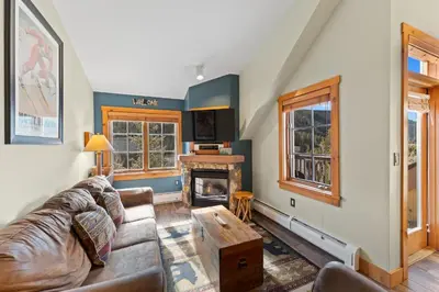 a living room with a couch and a fireplace at Expedition Station 8633 in Keystone