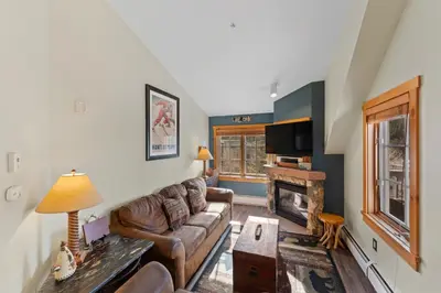 a living room with a couch and a fireplace at Expedition Station 8633 in Keystone