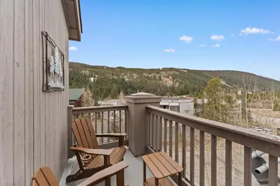 a balcony with two chairs and a view of the mountains at Expedition Station 8633 in Keystone