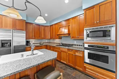 a kitchen with wooden cabinets and stainless steel appliances at Lone Eagle 3024 in Keystone