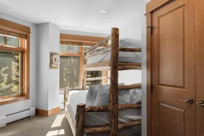 a bedroom with a wooden bunk bed and a window at Lone Eagle 3024 in Keystone