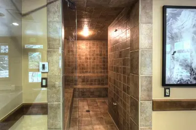 a bathroom with a shower with a television on the wall at Lone Eagle 3024 in Keystone