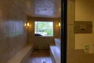 a walk in shower with a tub and a window at Expedition Station 8553 in Keystone