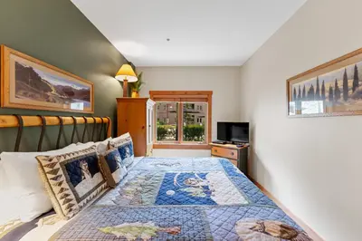 a bedroom with a king sized bed and a window at Expedition Station 8553 in Keystone