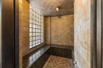 a tiled bathroom with a tub in a room at Springs 8887 in Keystone