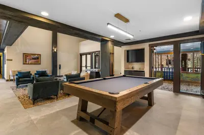 a living room with a pool table in it at Springs 8887 in Keystone