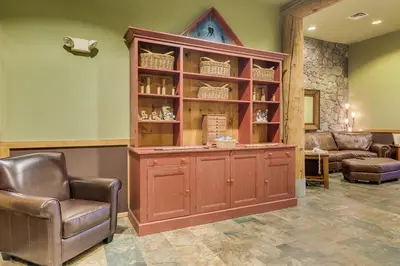 a large wooden cabinet in a room with two chairs at Arap Ldg 8101 in Keystone