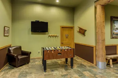 a game room with a table and a chair at Arap Ldg 8101 in Keystone