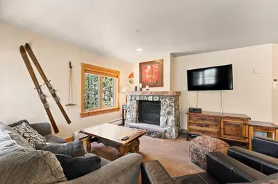 a living room with a couch and a fireplace at Expedition Station 8603 in Keystone